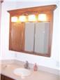 Red oak medicine cabinet with mirror doors - Corian solid surface countertop with integral sink