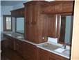 Red oak cabinets - Raised panel doors and drawer fronts - Full overlay style - Corian solid surface countertops with integral sinks