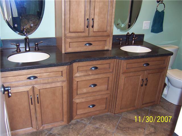 Maple cabinets stained and glazed - Flat panel doors and drawer fronts - Full overlay style - Corian solid surface countertop with integral sinks