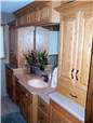 Red oak cabinets - Raised panel doors - Standard overlay style - Corian solid surface countertops with an integral sink