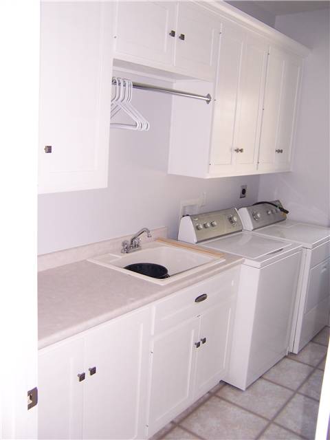 Painted cabinets - Laminate countertop - Clothes rod