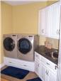 Painted cabinets - Laminate countertop - Wood drawers under the washer and dryer