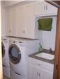 Painted cabinets - Laminate countertop with an undermount utility sink - Clothes rod