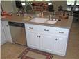 Solid surface peninsula countertop with an undermount solid surface sink