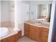 Solid surface countertop, undermount sink, tub deck, and backsplash