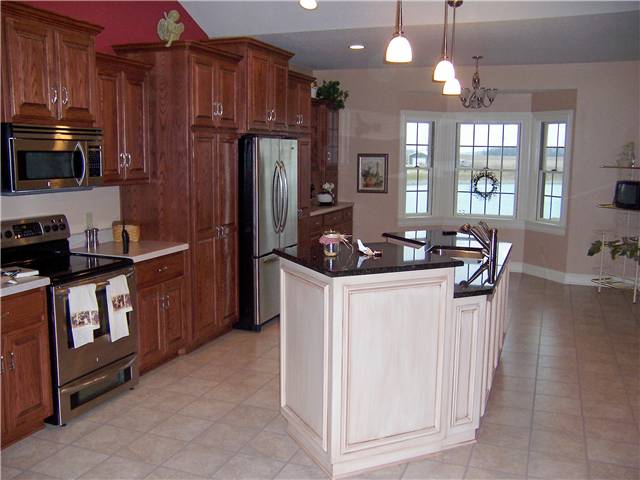 Red oak cabinets with a painted and glazed island - Raised panel doors - Standard overlay style - Dual level granite countertop on the islnnd