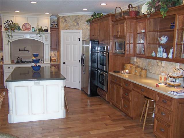 Hickory cabinets - Painted island and cooking area - Flat panel miter corner doors, drawer fronts, and side panels - Corian solid surface countertops