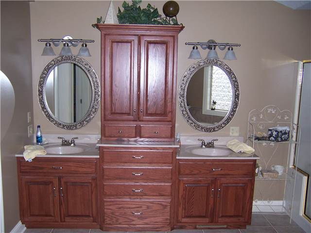 Red oak cabinets - Raised panel doors - Standard overlay style - Cultured marble countertops with integral sinks
