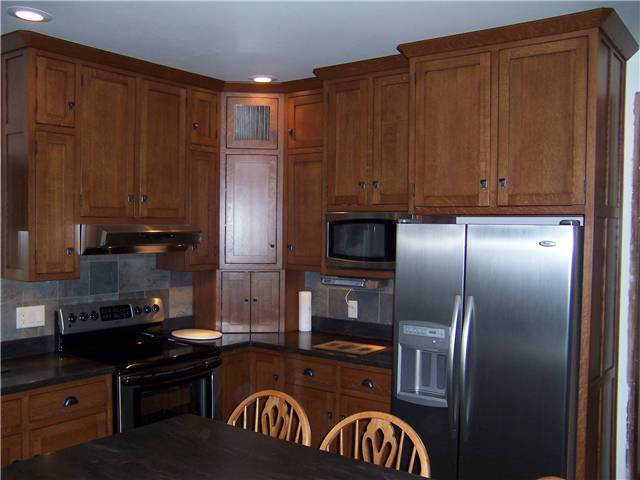 Quartersawn white oak cabinets - Flat panel doors - Inset style - Corian solid surface countertops