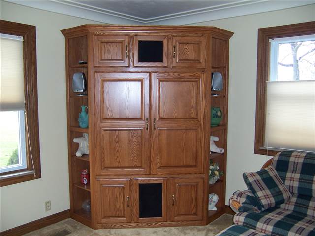 Entertainment center with pocket doors - stained oak