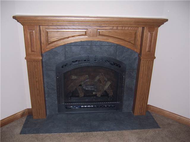 Fireplace mantel - stained oak with panels & fluting