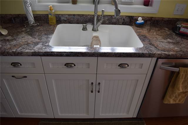 Painted cabinets with flat panel beadboard doors - full overlay style - Karran undermount sink - laminate countertop