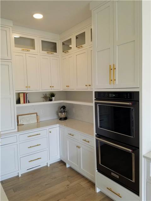 Painted cabinets with floating shelf under upper cabinets - Quartz countertop & backsplash
