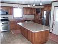 Red oak cabinets - Raised panel doors and drawer fronts - Full overlay style - Corian solid surface countertops