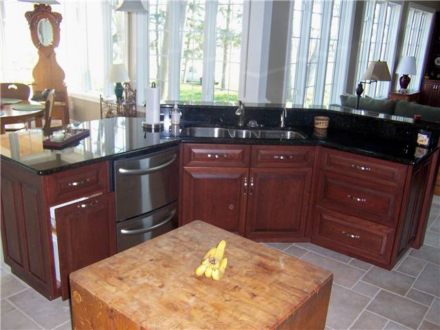Cherry island - Raised panel miter corner doors and drawer fronts - Full overlay style - Granite countertop with a stainless steel undermount sink