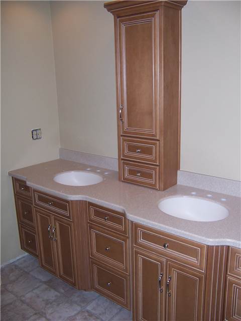 Maple cabinets stained and glazed - Flat panel miter corner doors and drawer fronts - Full overlay style - Corian solid surface coubtertop with integral sinks