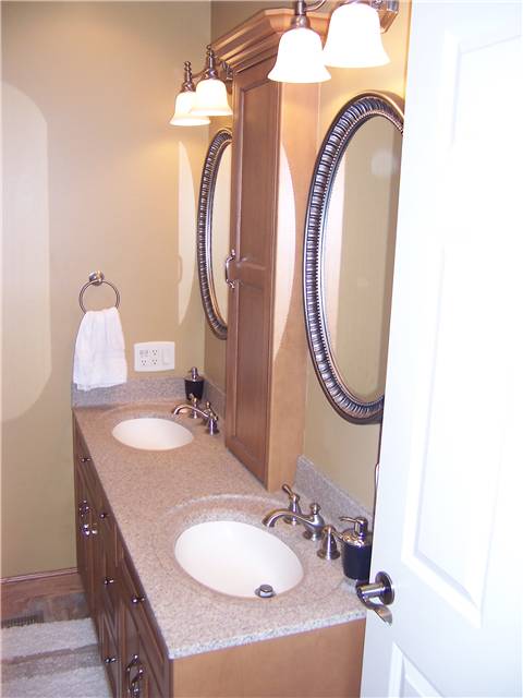 Maple cabinets - Flat panel doors and drawer fronts - Full overlay style - Cultured granite countertop with integral sinks