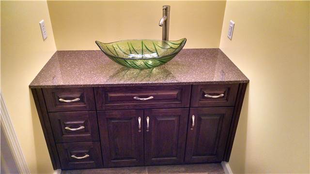 Stained hickory cabinet - cultured granite countertop - glass vessel sink