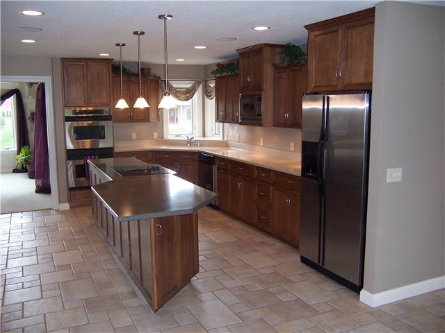 Maple cabinets - Flat panel doors, drawer fronts, and side panels - Full overlay style - Corian solid surface countertops
