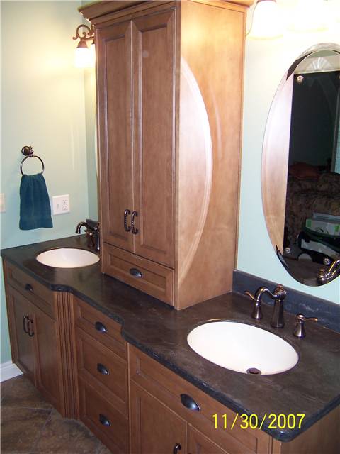 Maple cabinets stained and glazed - Flat panel doors and drawer fronts - Full overlay style - Corian solid surface countertop with integral sinks